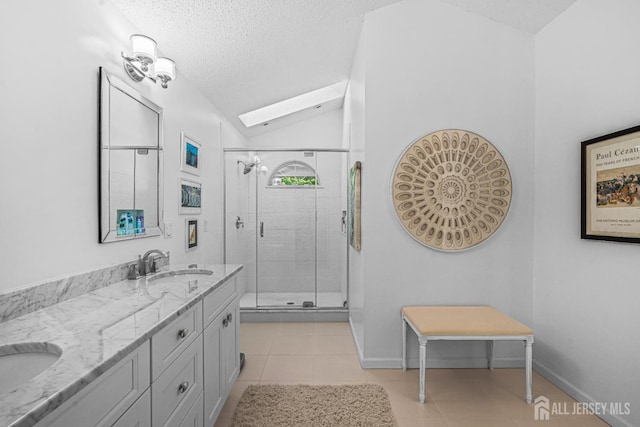 5 Fairway Blvd Unit 5, Monroe, NJ 08831 - bathroom featuring a stall shower, double vanity, a textured ceiling, lofted ceiling, and tile patterned flooring