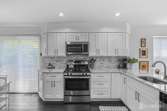 5 Fairway Blvd Unit 5, Monroe, NJ 08831 - kitchen with stainless steel appliances, tasteful backsplash, light stone countertops, white cabinetry, and recessed lighting