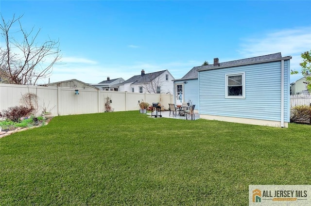 back of house with a lawn, a patio, and a fenced backyard