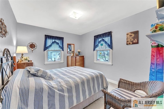 carpeted bedroom with baseboards