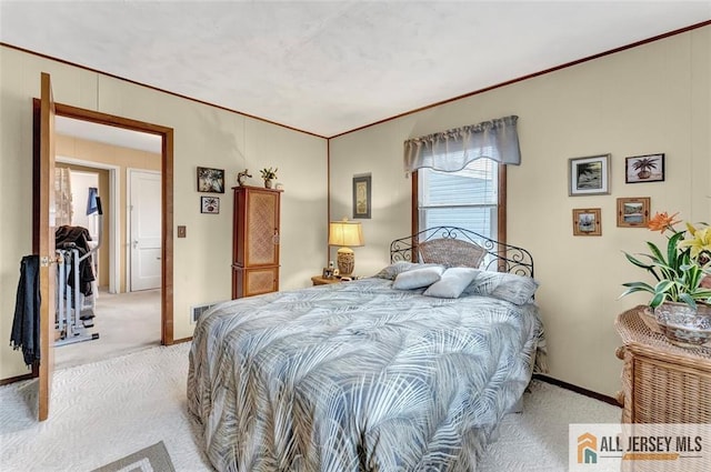 bedroom with light colored carpet, baseboards, and crown molding