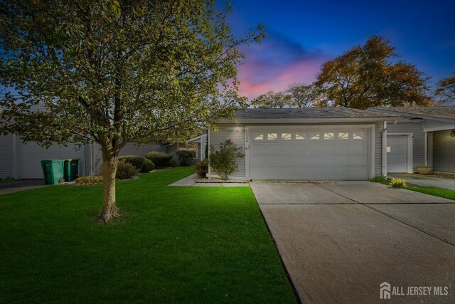 view of front of house featuring a lawn and a garage