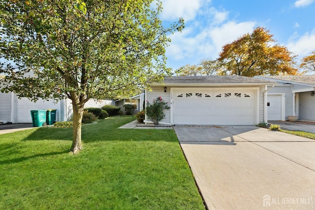 view of front of property featuring a garage and a front yard