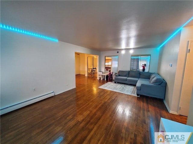 living room featuring a baseboard radiator, baseboards, and wood finished floors