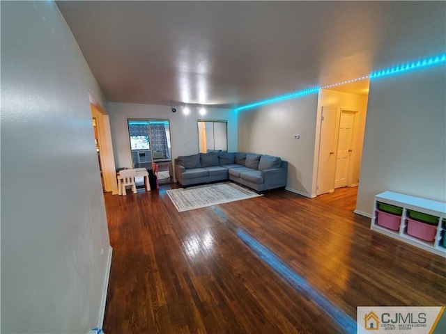 living room with baseboards and wood finished floors