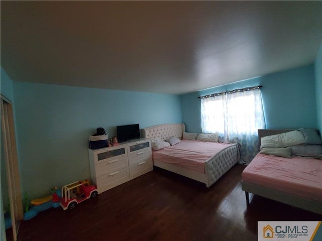 bedroom with dark wood-type flooring