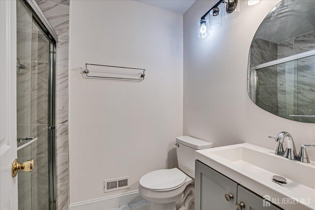 bathroom with a stall shower, visible vents, toilet, marble finish floor, and vanity