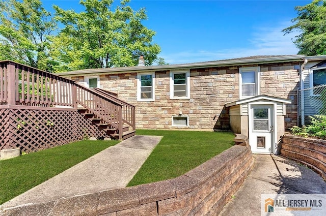 71 Russell St, Woodbridge Proper, NJ 07095 - rear view of property featuring stone siding, a chimney, a yard, stairs, and a wooden deck