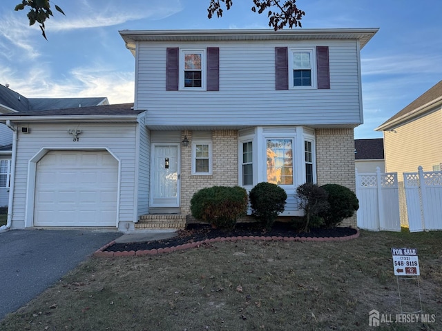 51 Tanbark Dr, Sayreville, NJ 08859 - view of front facade featuring a garage and asphalt driveway