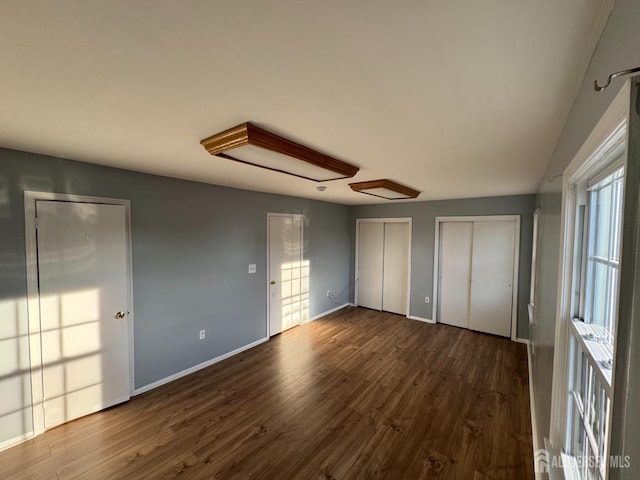 51 Tanbark Dr, Sayreville, NJ 08859 - unfurnished bedroom featuring multiple closets and dark wood-style flooring