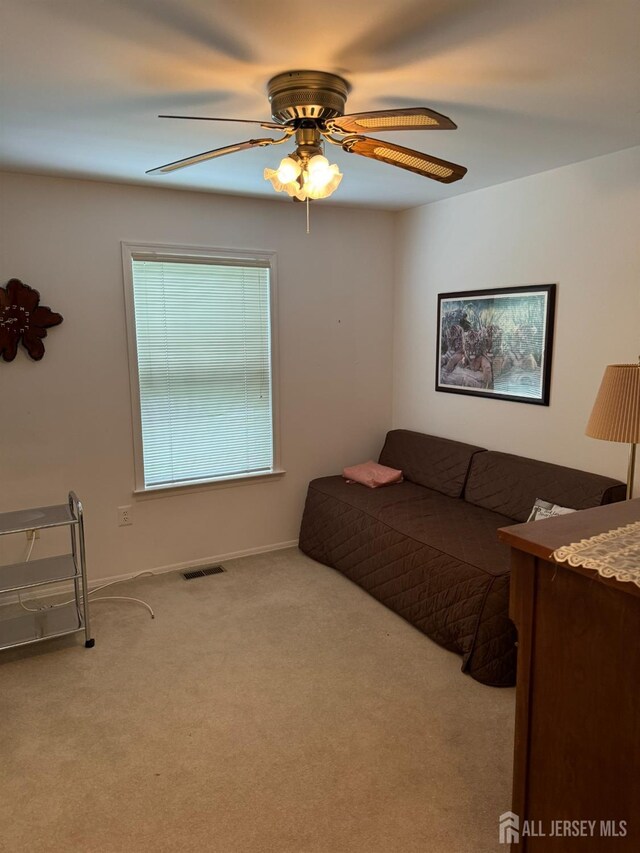 bedroom featuring ceiling fan and light colored carpet