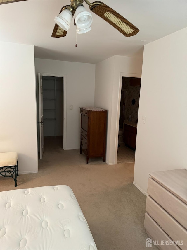 bedroom featuring light carpet, ceiling fan, and baseboards