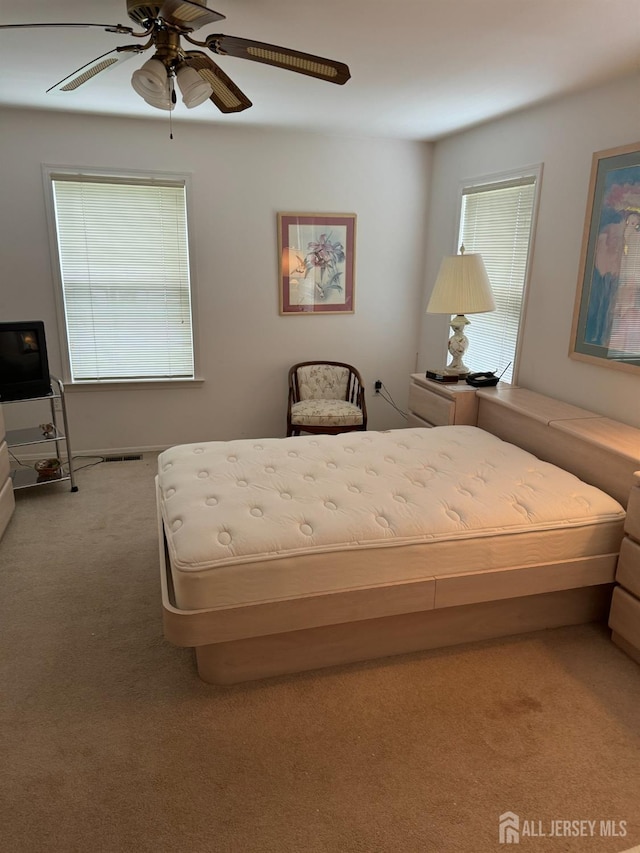 bedroom featuring ceiling fan, carpet flooring, and visible vents