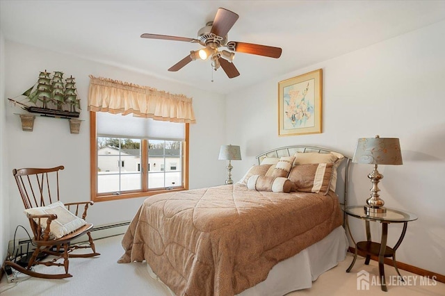 carpeted bedroom with baseboard heating and ceiling fan