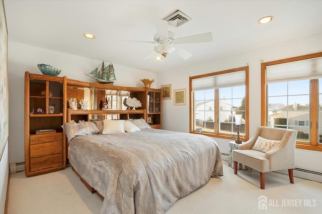 bedroom with recessed lighting, visible vents, light colored carpet, and baseboard heating