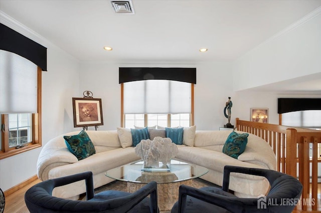 living area featuring visible vents, ornamental molding, wood finished floors, recessed lighting, and baseboards