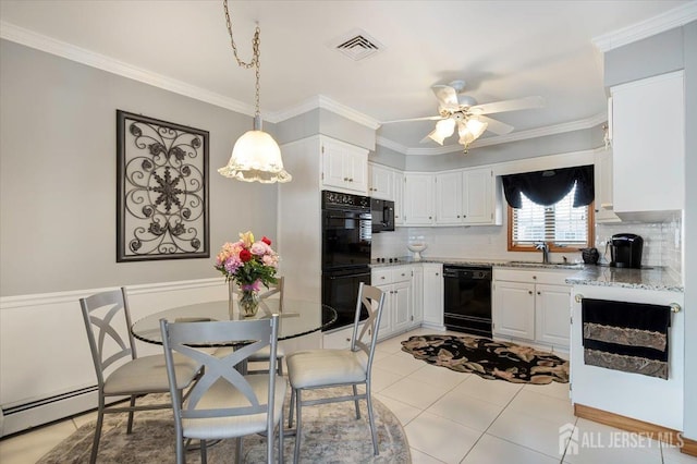 kitchen with visible vents, a baseboard radiator, a sink, black appliances, and crown molding