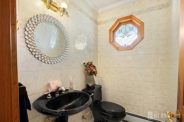 bathroom featuring crown molding, a baseboard heating unit, toilet, tile walls, and a sink