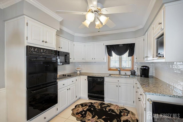 kitchen with black appliances, ornamental molding, light stone countertops, and a sink