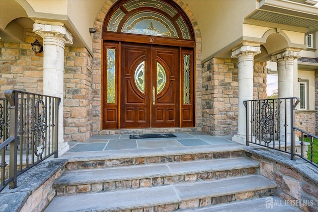 87 Ellmyer Rd, Edison, NJ 08820 - doorway to property with stone siding and covered porch