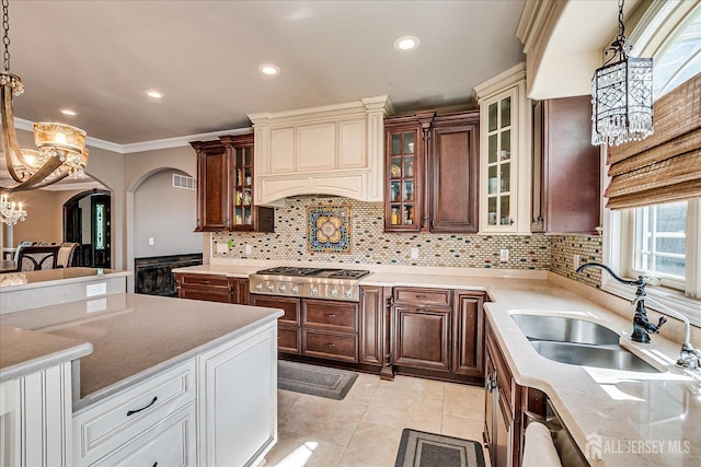 87 Ellmyer Rd, Edison, NJ 08820 - kitchen featuring stainless steel gas stovetop, a chandelier, arched walkways, decorative backsplash, and hanging light fixtures