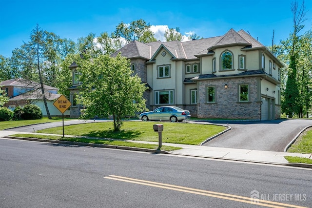 87 Ellmyer Rd, Edison, NJ 08820 - french country inspired facade with stone siding, asphalt driveway, stucco siding, a garage, and a front lawn
