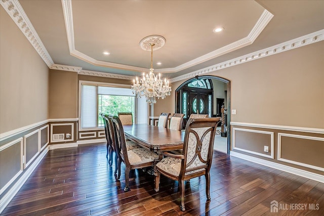 87 Ellmyer Rd, Edison, NJ 08820 - dining area with a raised ceiling, arched walkways, a chandelier, crown molding, and dark wood-style floors