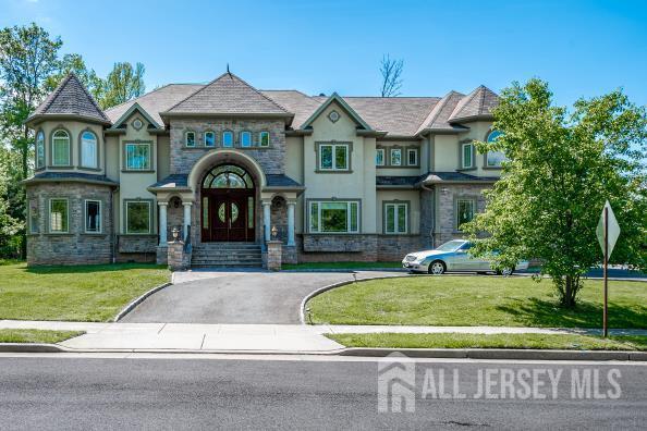 87 Ellmyer Rd, Edison, NJ 08820 - french country home featuring stone siding, a front yard, and stucco siding