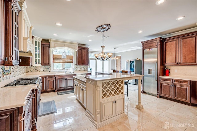 87 Ellmyer Rd, Edison, NJ 08820 - kitchen with built in fridge, a chandelier, decorative backsplash, a kitchen breakfast bar, and a kitchen island