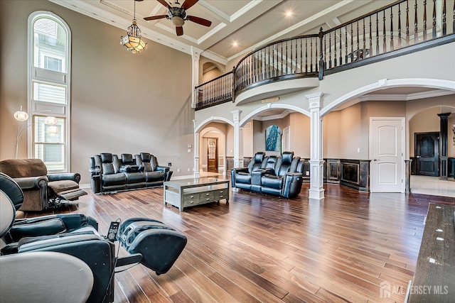 87 Ellmyer Rd, Edison, NJ 08820 - living area with decorative columns, arched walkways, a towering ceiling, a ceiling fan, and wood finished floors