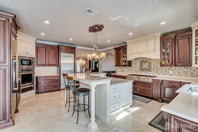 87 Ellmyer Rd, Edison, NJ 08820 - kitchen featuring built in appliances, a chandelier, decorative backsplash, a kitchen island, and a breakfast bar