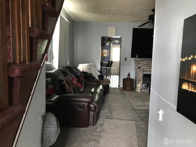 335 Alpine St, Perth Amboy, NJ 08861 - living area with a fireplace, ceiling fan, carpet, and a textured ceiling