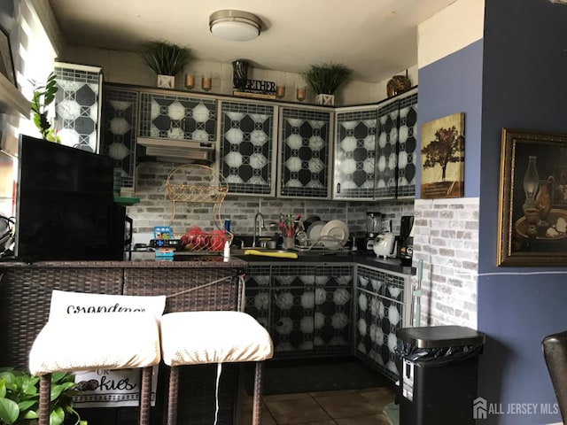 335 Alpine St, Perth Amboy, NJ 08861 - kitchen with dark countertops, tile patterned floors, and backsplash