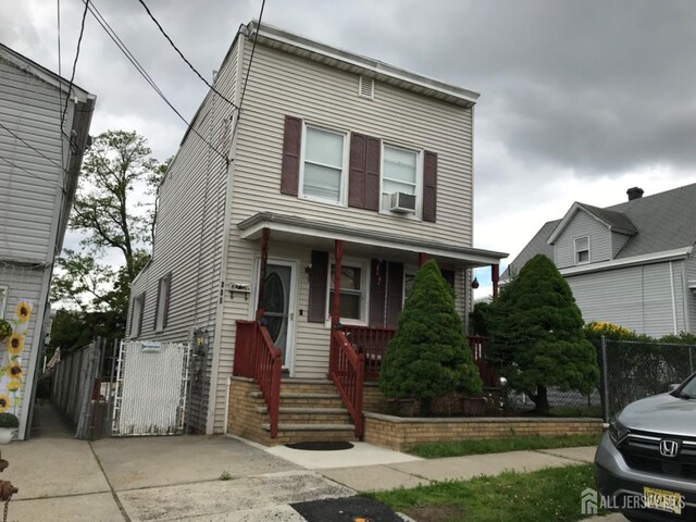335 Alpine St, Perth Amboy, NJ 08861 - view of front facade with a porch, a gate, and cooling unit