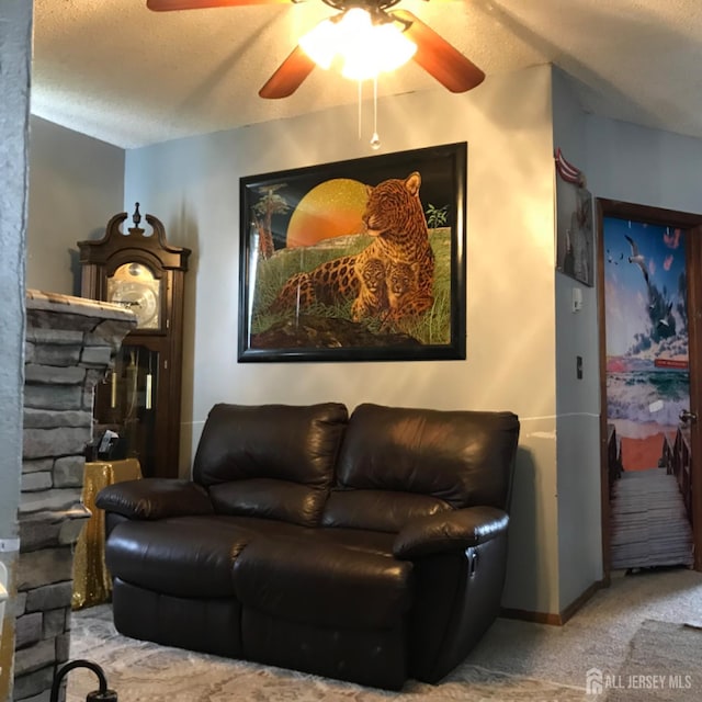 335 Alpine St, Perth Amboy, NJ 08861 - living area with a ceiling fan, carpet floors, a textured ceiling, a fireplace, and baseboards