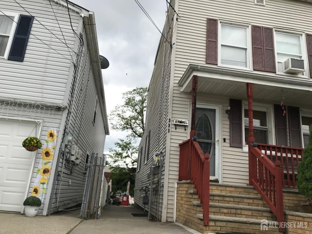 335 Alpine St, Perth Amboy, NJ 08861 - view of side of home featuring cooling unit, a garage, and a porch