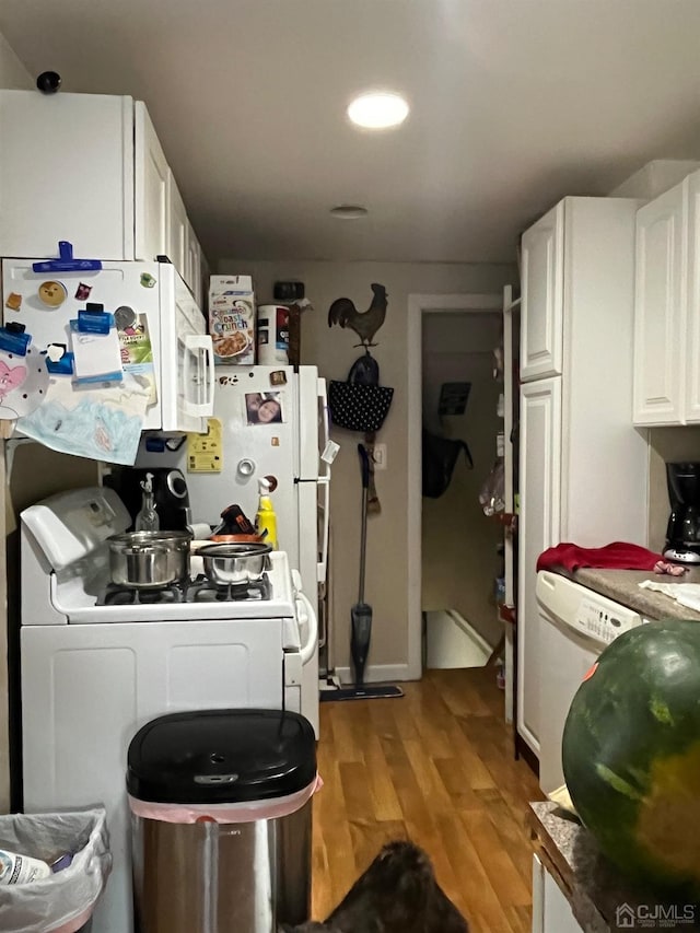 kitchen featuring white cabinetry, light wood-type flooring, and white appliances