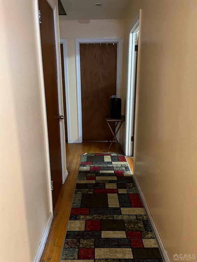 corridor featuring dark wood-type flooring