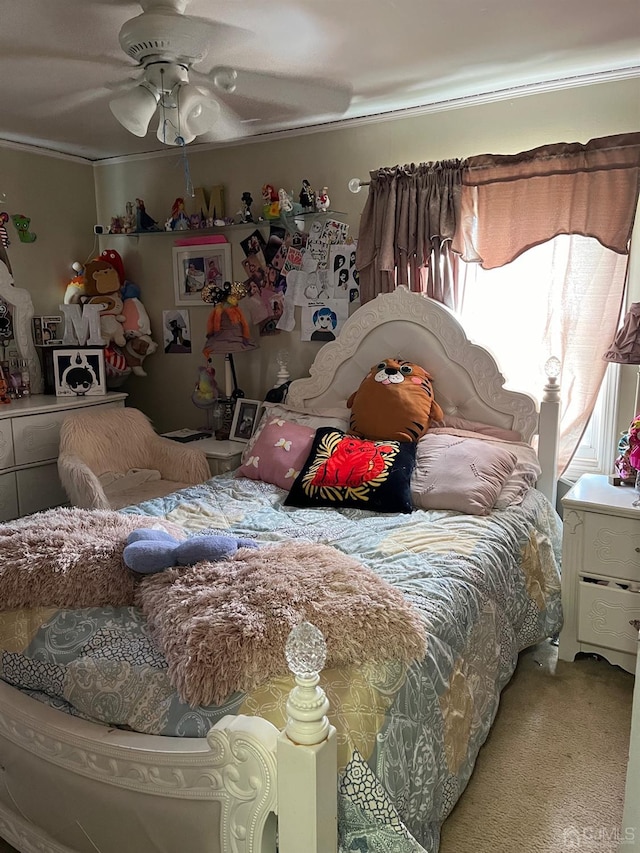 bedroom featuring ornamental molding, ceiling fan, and carpet floors