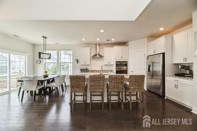 20 Metro Dr, Monroe, NJ 08831 - kitchen with appliances with stainless steel finishes, wall chimney range hood, dark wood finished floors, white cabinets, and decorative backsplash