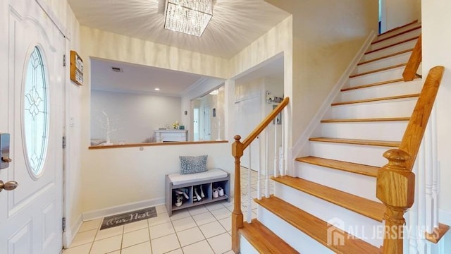 entrance foyer with stairs, baseboards, and light tile patterned floors