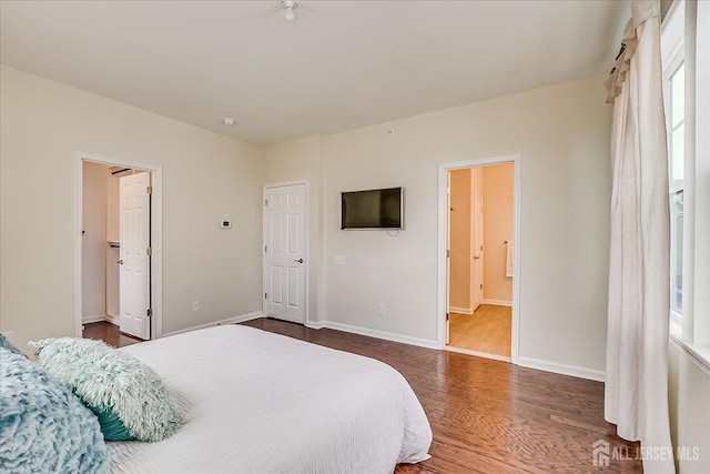 bedroom with dark hardwood / wood-style floors