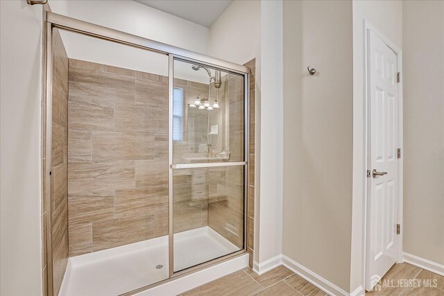 bathroom featuring a shower with shower door