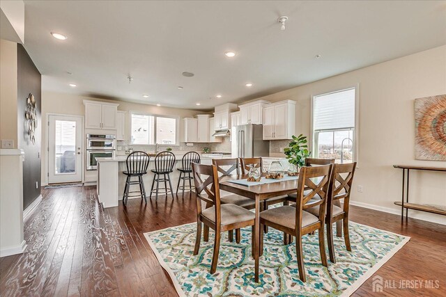 dining area with dark hardwood / wood-style flooring