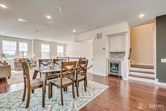 dining space featuring wine cooler and dark hardwood / wood-style floors