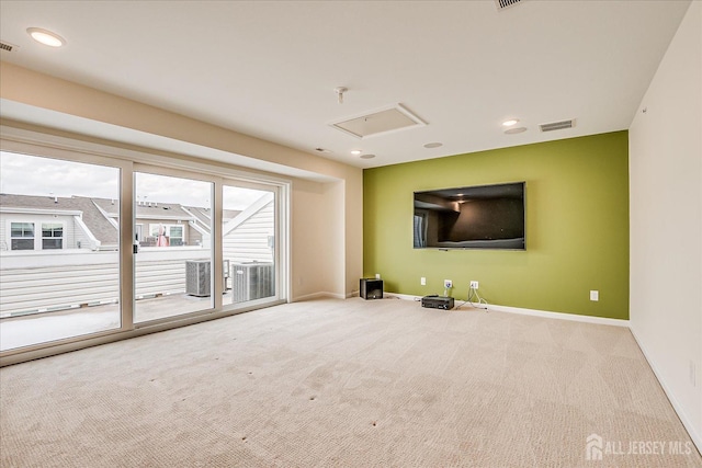 unfurnished living room featuring light carpet