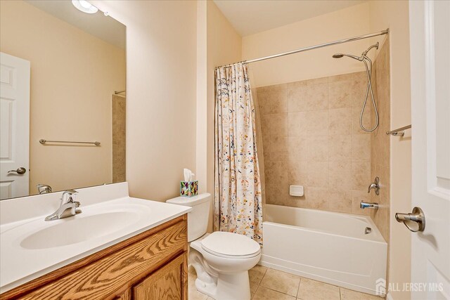 full bathroom featuring shower / bathtub combination with curtain, vanity, toilet, and tile patterned flooring