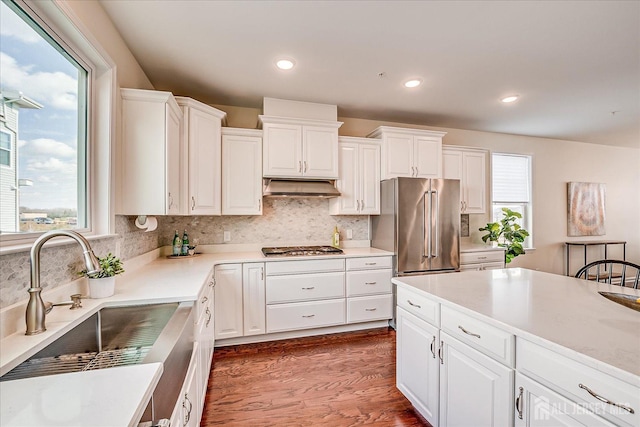 kitchen featuring appliances with stainless steel finishes, sink, and white cabinets