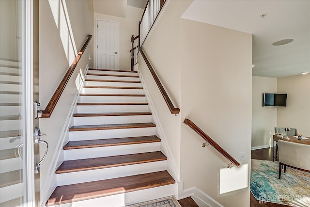 stairs featuring wood-type flooring