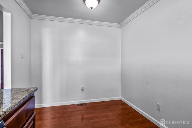 93 Ember Ln, Willingboro, NJ 08046 - unfurnished dining area featuring dark wood-style flooring, crown molding, and baseboards
